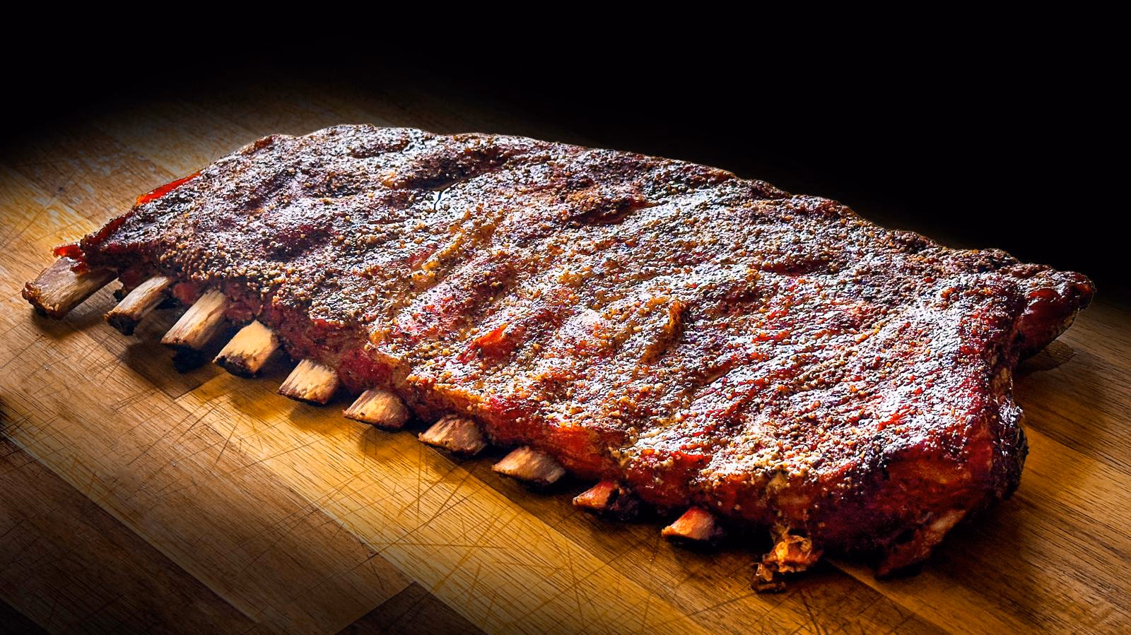 Ribs de porc fumés au bois sur une planche